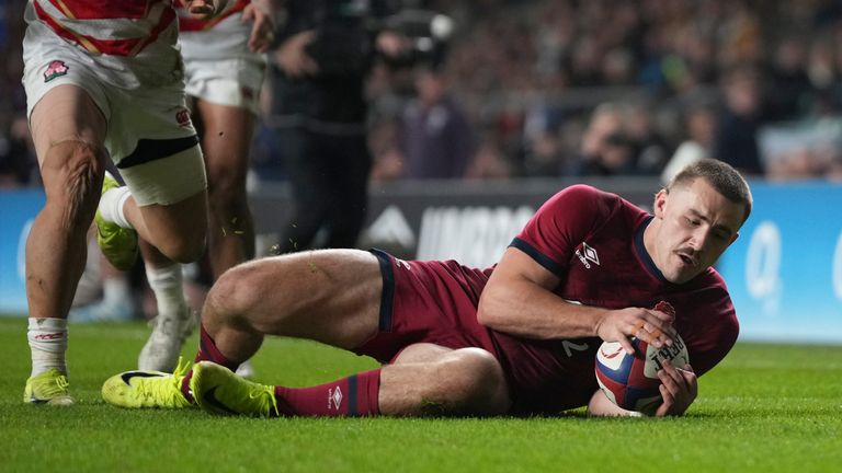 Ollie Sleightholme goes over the line to score England's fifth try (AP Photo/Alastair Grant)