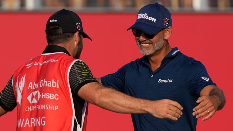 Paul Waring of England celebrates with his caddie after winning the Abu Dhabi Golf Championship in Abu Dhabi, United Arab Emirates, Sunday, Nov. 10, 2024. (AP Photo/Altaf Qadri) 