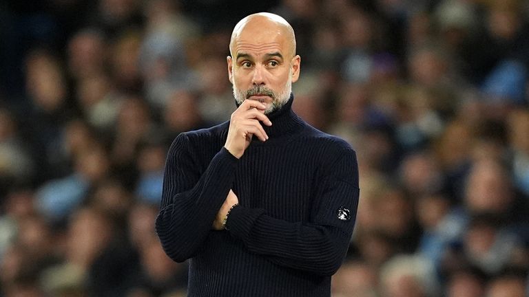 Pep Guardiola looks on from the touchline