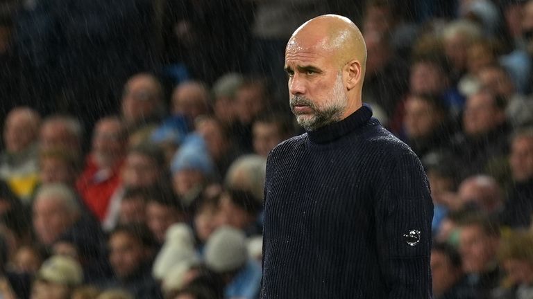 Pep Guardiola looks on from the touchline