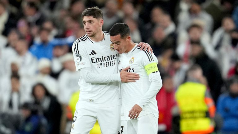 Real Madrid's Federico Valverde and Lucas Vazquez, right, react at the end of the Champions League opening phase soccer match between Liverpool and Real Madrid at Anfield Stadium, Liverpool, England, Wednesday, Nov. 27, 2024. (AP Photo/Jon Super)