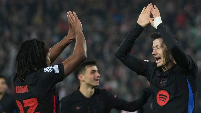 Barcelona's Robert Lewandowski, right, celebrates after scoring during the Champions League opening phase soccer match between Red Star and Barcelona at the Rajko Mitic Stadium in Belgrade, Serbia, Wednesday, Nov. 6, 2024. (AP Photo/Darko Vojinovic)