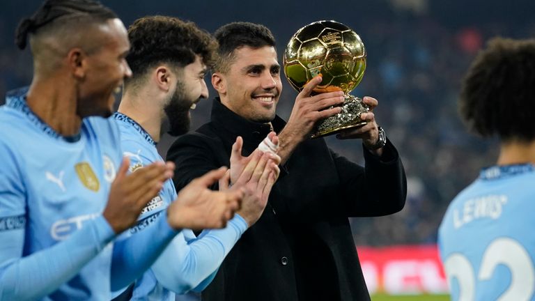 Rodri is applauded by team-mates as he shows off the Ballon d'Or trophy prior to Man City vs Spurs (AP Photo/Dave Thompson)