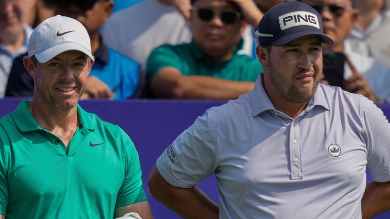 Rory McIlroy of Northern Ireland, left, and Thriston Lawrence of South Africa wait before the first tee off during the first round of World Tour Golf Championship in Dubai, United Arab Emirates, Thursday, Nov. 14, 2024. (AP Photo/Altaf Qadri)