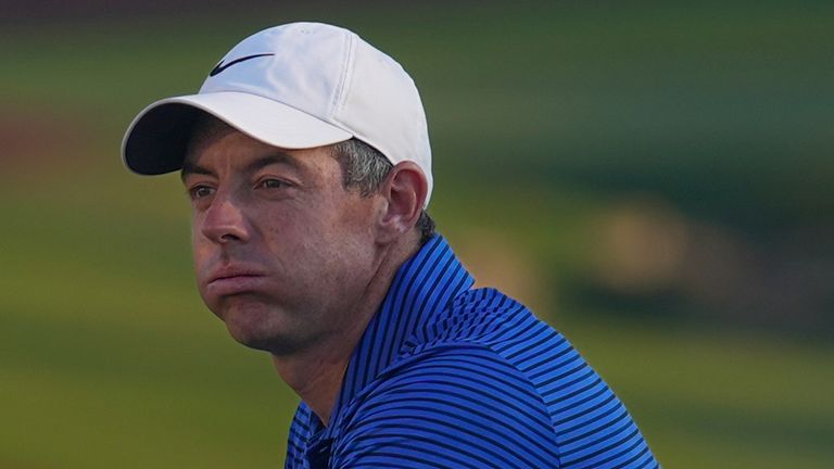 Rory McIlroy of Northern Ireland stands next Race to Dubai trophy during the award ceremony after winning the World Tour Golf Championship in Dubai, United Arab Emirates, Sunday, Nov. 17, 2024. (AP Photo/Altaf Qadri)