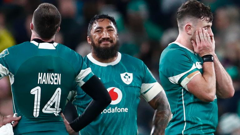 Ireland's Bundee Aki, centre smiles at team-mate Ireland's Mack Hansen