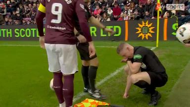 Ouch! The assistant takes one to the chin during Edinburgh derby!