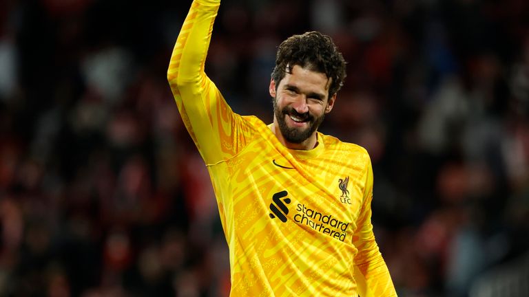 Liverpool's goalkeeper Alisson celebrates after their win