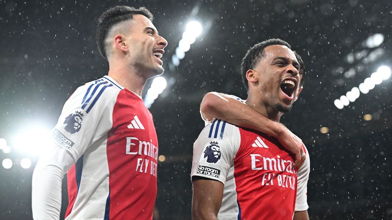 Jurrien Timber of Arsenal celebrates scoring his team's first goal with team-mates Gabriel Martinelli and Jakub Kiwior (obscured)