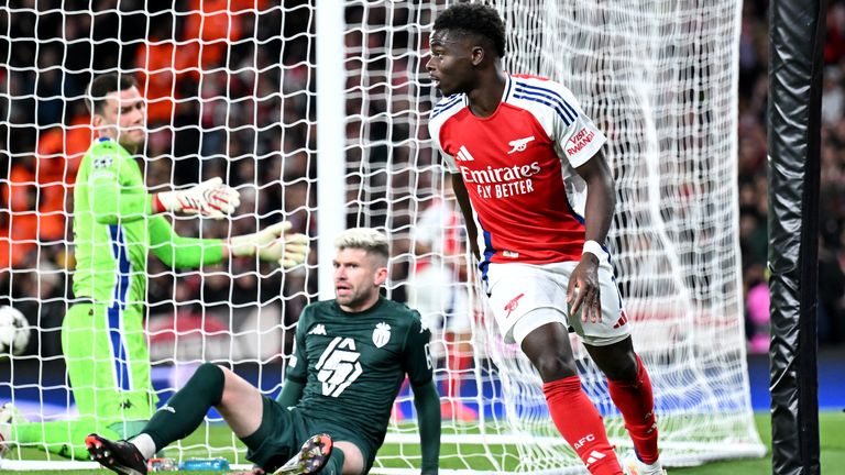 LONDON, ENGLAND - DECEMBER 11: Bukayo Saka of Arsenal celebrates scoring his team's first goal as Radoslaw Majecki of AS Monaco reacts after failing to make a save during the UEFA Champions League 2024/25 League Phase MD6 match between Arsenal FC and AS Monaco at Emirates Stadium on December 11, 2024 in London, England. (Photo by Stuart MacFarlane/Arsenal FC via Getty Images)