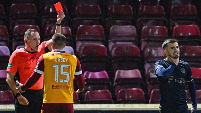 MOTHERWELL, SCOTLAND - DECEMBER 20: Referee Chris Graham shows Motherwell's Dan Casey (L) a red card for violent conduct against Kilmarnock's Danny Armstrong (centre) during a William Hill Premiership match between Motherwell and Kilmarnock at Fir Park, on December 20, 2024, in Motherwell, Scotland.  (Photo by Rob Casey / SNS Group)