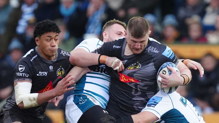 Exeter Chiefs Jacques Vermeulen is tackled by Gloucester's Ruan Ackermann and Seb Blake