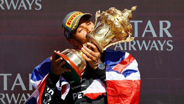 SILVERSTONE CIRCUIT, UNITED KINGDOM - JULY 07: Sir Lewis Hamilton, Mercedes-AMG F1 Team, 1st position, kisses the winners trophy during the British GP at Silverstone Circuit on Sunday July 07, 2024 in Northamptonshire, United Kingdom. (Photo by Andy Hone / LAT Images)