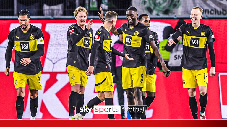 22 December 2024, Lower Saxony, Wolfsburg: Soccer: Bundesliga, VfL Wolfsburg - Borussia Dortmund, Matchday 15, Volkswagen Arena. Dortmund's Julian Brandt (M) applauds Dortmund's Serhou Guirassy after his goal to make it 0-3. Photo by: Swen Pf'rtner/picture-alliance/dpa/AP Images