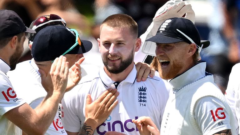 Gus Atkinson is mobbed by his England team-mates after taking a hat-trick on day two of the second Test against New Zealand