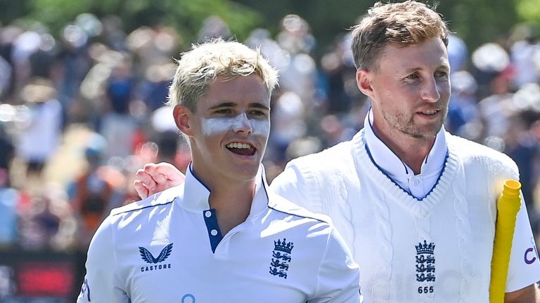 England's Jacob Bethell, left, and teammate Joe Root walk from the field following their eight wicket win in the first cricket test against New Zealand at Hagley Oval in Christchurch, New Zealand, Sunday, Dec. 1, 2024.(John Davidson/Photosport via AP)