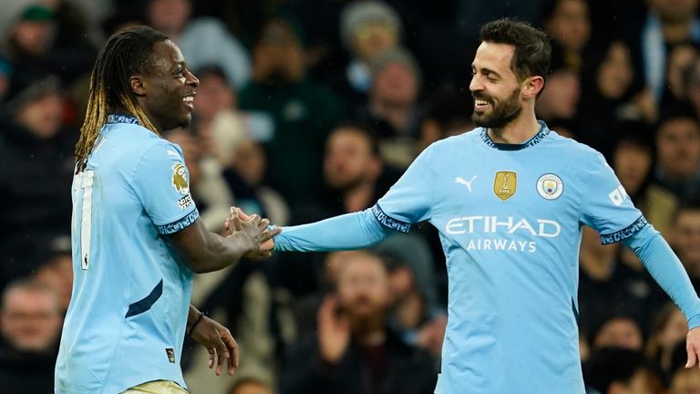 Manchester City's Jeremy Doku celebrates after scoring his side's third goal with Bernardo Silva (AP Photo/Dave Thompson)