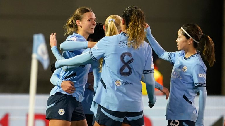 Manchester City's Kerstin Casparij, left, celebrates with her teammates