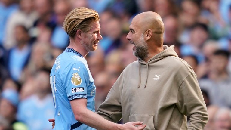 Manchester City's head coach Pep Guardiola talks with Kevin De Bruyne after being substitute during the English Premier League soccer match between Manchester City and Ipswich Town at the Etihad Stadium in Manchester, England, Saturday, Aug. 24, 2024. (AP Photo/Dave Thompson)