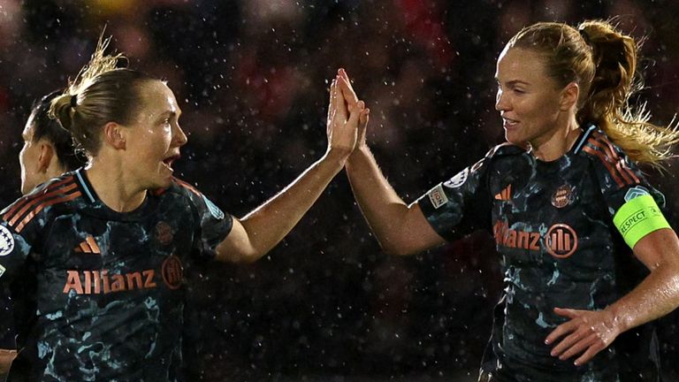 Bayern Munich's Swedish defender #05 Magdalena Eriksson (C) celebrates the team's first goal with Bayern Munich's Icelandic defender #04 Glodis Viggosdottir (R) during the Women's UEFA Champions League group C football match between Arsenal and Bayern Munich at Meadow Park, in north London, on December 18, 2024. (Photo by Adrian Dennis / AFP)