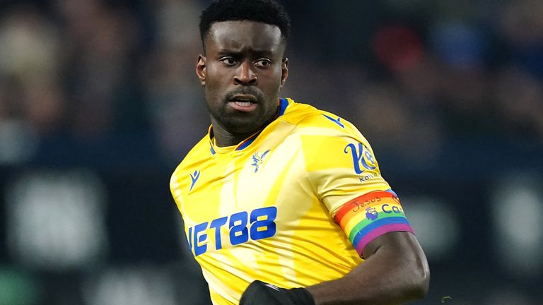 Crystal Palace captain Marc Guehi wears a Rainbow Laces armband with the words 'Jesus Heart You' written across it