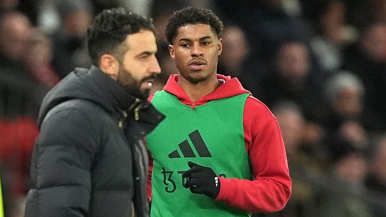 Marcus Rashford warms up as Ruben Amorim look on