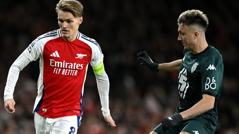 LONDON, ENGLAND - DECEMBER 11: Martin Odegaard of Arsenal passes the ball whilst under pressure from Aleksandr Golovin of AS Monaco during the UEFA Champions League 2024/25 League Phase MD6 match between Arsenal FC and AS Monaco at Emirates Stadium on December 11, 2024 in London, England. (Photo by Justin Setterfield/Getty Images)