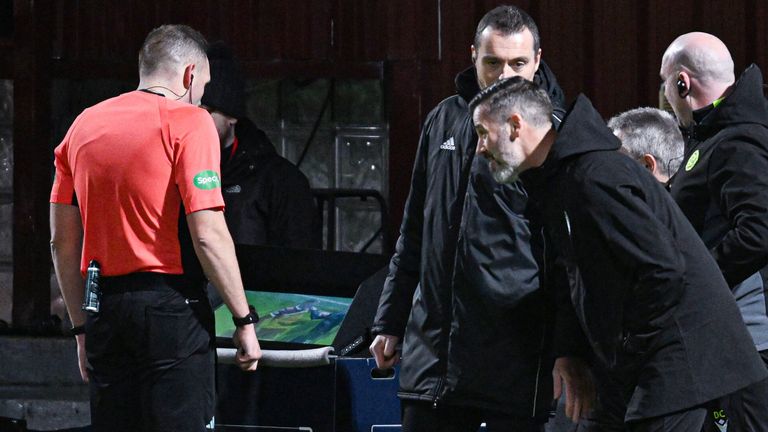 MOTHERWELL, SCOTLAND - DECEMBER 20: Referee Chris Graham consults VAR before confirming a red card for Motherwell's Dan Casey while Manager Stuart Kettlewell watches on during a William Hill Premiership match between Motherwell and Kilmarnock at Fir Park, on December 20, 2024, in Motherwell, Scotland.  (Photo by Rob Casey / SNS Group)