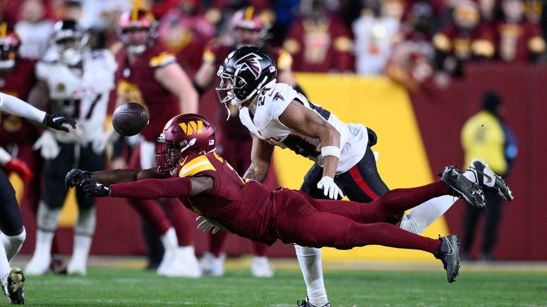 Washington Commanders wide receiver Terry McLaurin reaches in vain for an incomplete pass as Atlanta Falcons cornerback A.J. Terrell (24) defends during the second half of an NFL football game, Sunday, Dec. 29, 2024, in Landover, Md. (AP Photo/Nick Wass)