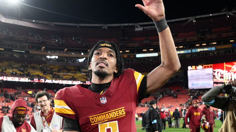 Washington Commanders quarterback Jayden Daniels (5) waves to the crowd after an overtime victory over the Atlanta Falcons during an NFL football game, Sunday, Dec. 29, 2024, in Landover, Md. The Commanders won 30-24. (AP Photo/Nick Wass)