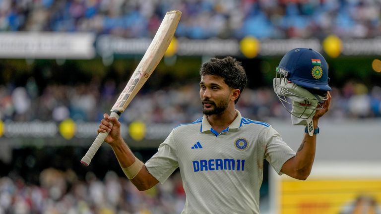 India's Nitish Kumar Reddy acknowledges the crowd as he leaves the field after poor light stopped play during day three of the fourth cricket test between Australia and India at the Melbourne Cricket Ground, Melbourne , Australia, Saturday, December 28, 2024. (AP Photo/Asanka Brendon Ratnayake)