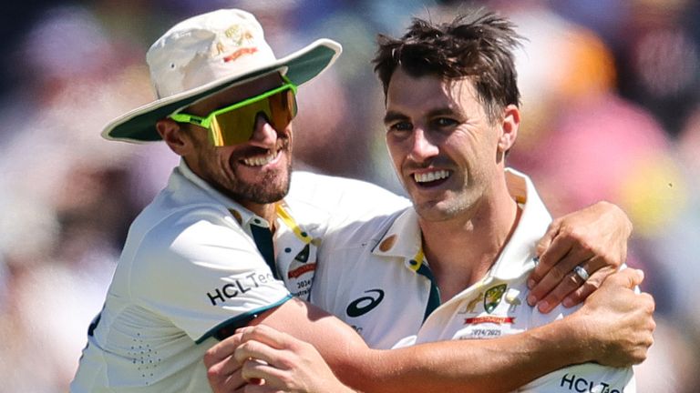 Mitchell Starc and Pat Cummins celebrate as the Australian captain claimed a five-for on day three to set up their 10-wicket win over India in the second Test in Adelaide