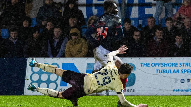 A penalty was initially awarded when Ross County's Michee Efete brought down Hearts' James Penrice