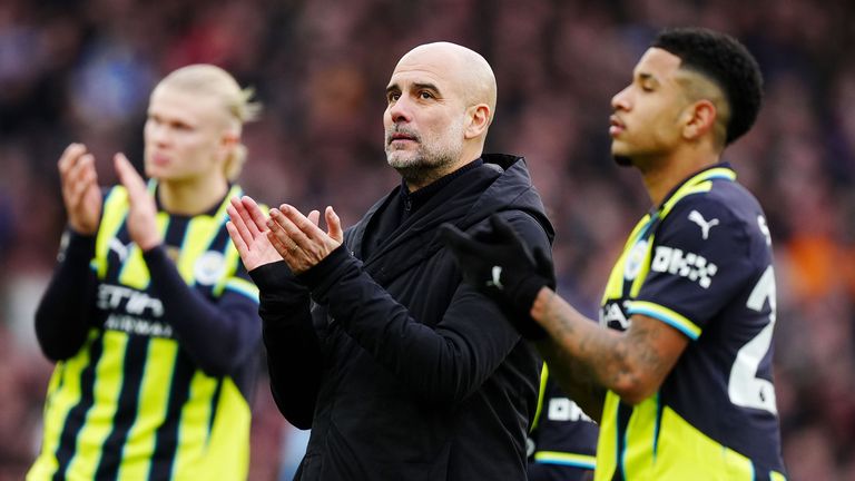 Manchester City manager Pep Guardiola and his players applaud the travelling fans