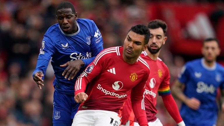 Abdoulaye Doucoure and Casemiro vie for the ball 