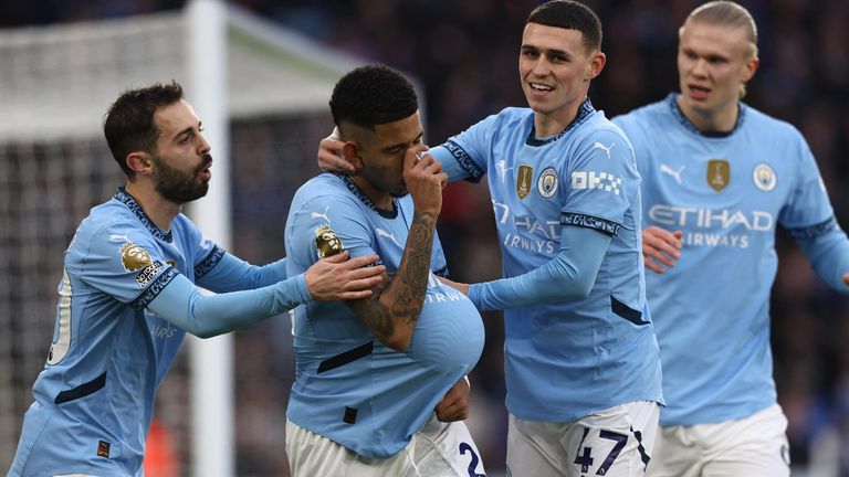 Savinho celebrates with his team-mates after giving Man City a first-half lead at Leicester