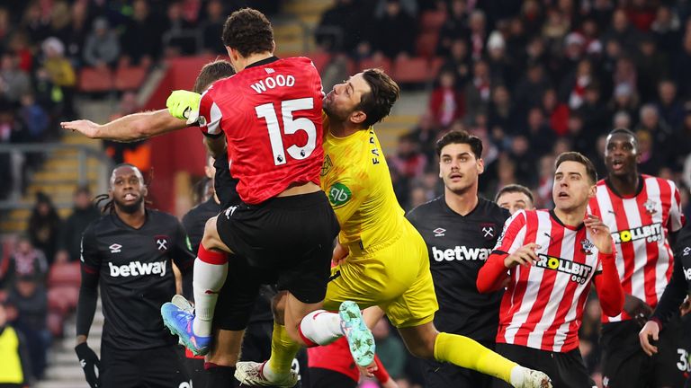 Lukasz Fabianski collides with Nathan Wood