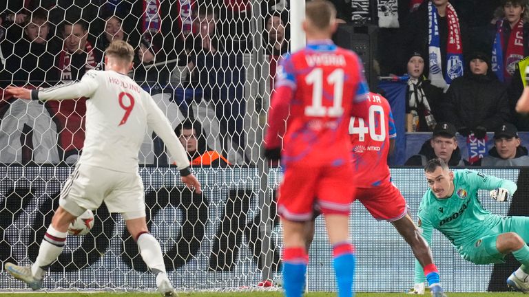 Manchester United's Rasmus Hoglund, left, scores his team's opening goal during the Europa League soccer match between Viktoria Plzeň and Manchester United at Dusan Arena in Plzeň, Czech Republic, Thursday, December 12, 2024. (AP Photo/Peter David Gosek)