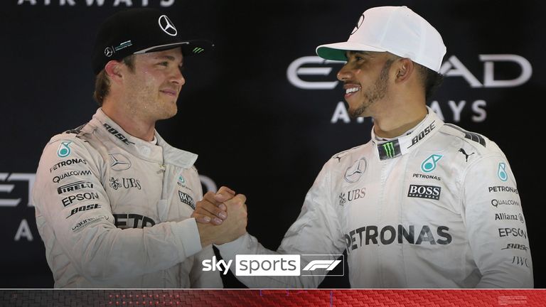 This is a Sunday, Nov. 27, 2016 file photo of Mercedes driver Lewis Hamilton of Britain, right, congratulates Mercedes driver Nico Rosberg of Germany, after Rosburg became world champion during the podium ceremony after the Emirates Formula One Grand Prix at the Yas Marina racetrack in Abu Dhabi, United Arab Emirates. Hamilton can first in the race and Rosberg second. Rosberg announced Friday Dec. 2, 2016 that he will retire from Formula One racing. 