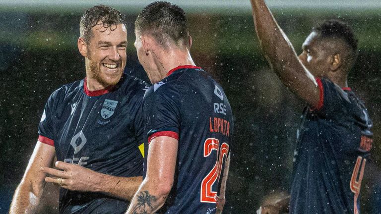 DINGWALL, SCOTLAND - DECEMBER 29: Ross County's Jordan White (L) celebrates at full time with Kacper Lopata and Akil Wright during a William Hill Premiership match between Ross County and Heart of Midlothian, on December 29, 2024, in Dingwall, Scotland. (Photo by Mark Scates / SNS Group)