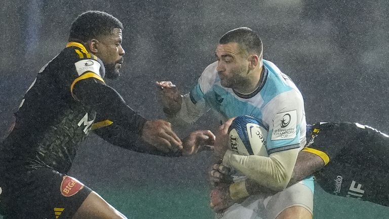 Bath's Will Muir (centre) is tackled by Stade Rochelais' Jack Nowell during the Investec Champions Cup match at the The Recreation Ground, Bath. Picture date: Friday December 6, 2024.