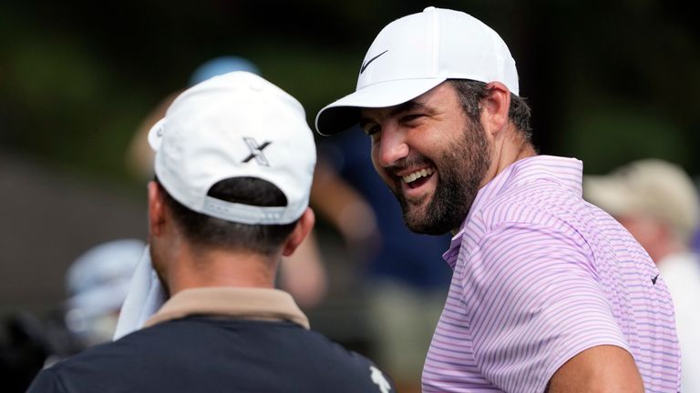 Scottie Scheffler, right, laughs with Xander Schauffele as they wait to tee off on the 14th hole during the first round of the St. Jude Championship golf tournament Thursday, Aug. 15, 2024, in Memphis, Tenn. (AP Photo/Mark Humphrey)