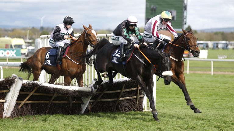 Strong Leader (black and green) on the way to winning the Liverpool Hurdle