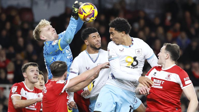 Middlesbrough goalkeeper Tom Glover (centre) attempts to claim the ball 