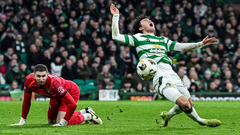 GLASGOW, SCOTLAND - DECEMBER 26: Motherwell goalkeeper Aston Oxborough brings down Celtic's Hyunjun Yang (R) in the box and is awarded a penalty during the William Hill Premiership match between Celtic and Motherwell at Celtic Park on December 26, 2024 in Glasgow, Scotland. (Photo: Rob Casey / SNS Group)