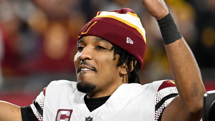 Washington Commanders quarterback Jayden Daniels (5) celebrates after an NFL wild-card playoff football game against the Tampa Bay Buccaneers in Tampa, Fla., Sunday, Jan. 12, 2025. (AP Photo/Jason Behnken) 