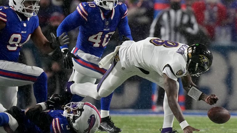 Baltimore Ravens quarterback Lamar Jackson (8) fumbles the ball as he is tackled by Buffalo Bills safety Damar Hamlin (3) during the second quarter of an NFL playoff football game, Sunday, Jan. 19, 2025, in Orchard Park , NY (AP Photo/Frank Franklin II)