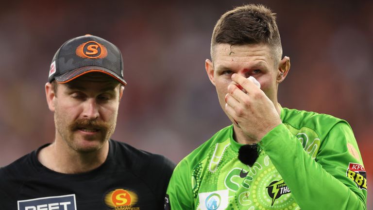 Cameron Bancroft is assisted from the field after colliding with Daniel Sams during Sydney Thunder's match against Perth Scorchers