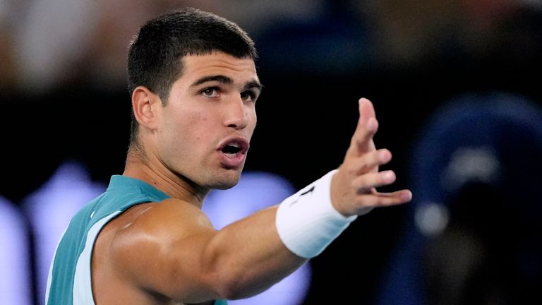 Carlos Alcaraz of Spain gestures as he speaks to the chair umpire during his quarterfinal match against Novak Djokovic of Serbia at the Australian Open tennis championship in Melbourne, Australia, Tuesday, Jan. 21, 2025. (AP Photo/Vincent Thian)