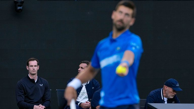 Andy Murray, coach of Novak Djokovic of Serbia watches him warm up for his first round match against Nishesh Basavareddy of the U.S. at the Australian Open tennis championship in Melbourne, Australia, Monday, Jan. 13, 2025. (AP Photo/Asanka Brendon Ratnayake)